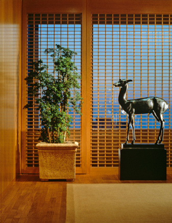 Main Corridor with View of Custom Screen Paneling at Window Wall with Sculpture